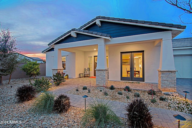 view of front facade with a porch and a garage