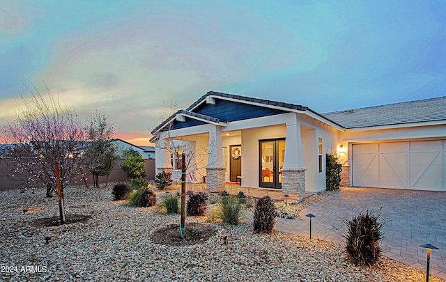 view of front facade with a porch and a garage