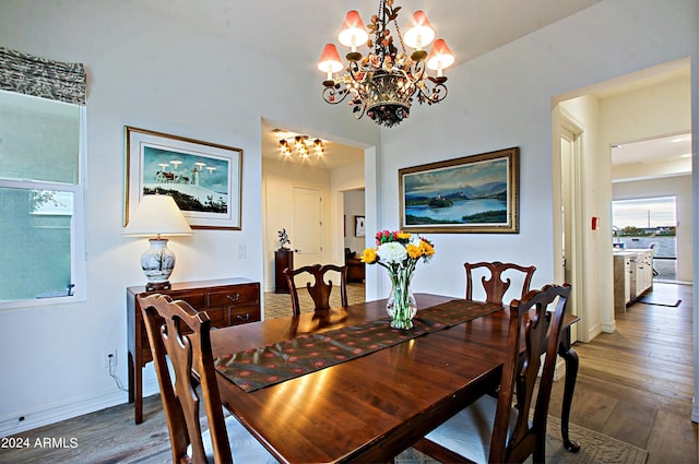 dining room with a notable chandelier and dark wood-type flooring