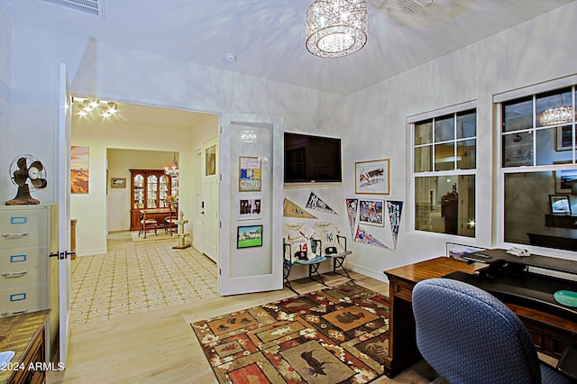 home office featuring a chandelier and light tile floors