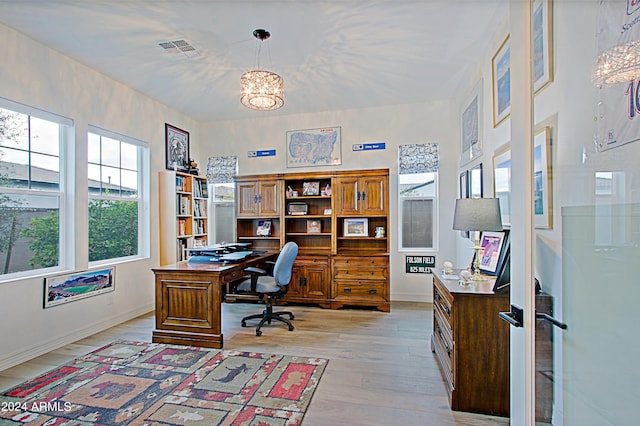 office space featuring an inviting chandelier and light wood-type flooring