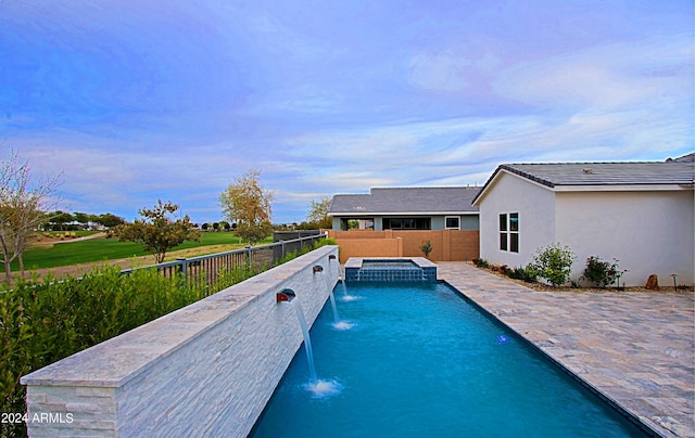 view of pool featuring pool water feature and a patio