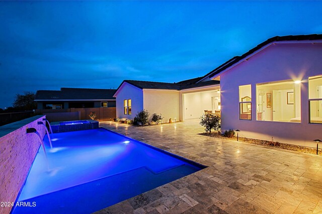 view of pool with pool water feature and a patio area