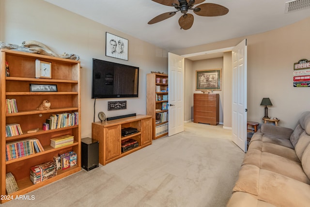 living room with ceiling fan and light colored carpet