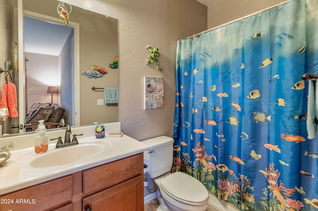 bathroom featuring a shower with curtain, vanity, and toilet