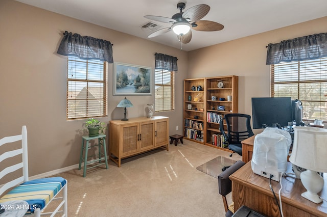 carpeted office space with ceiling fan