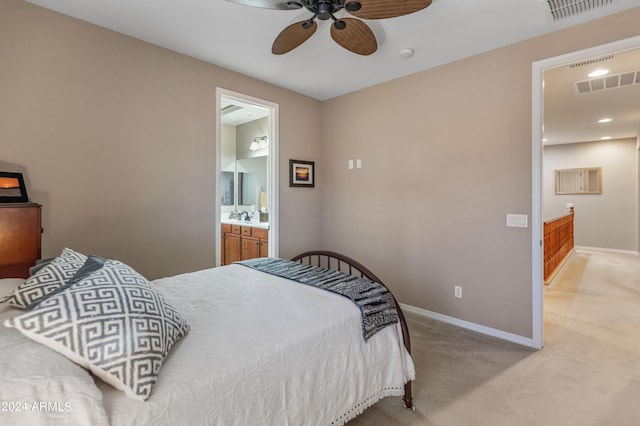 bedroom with light carpet, connected bathroom, ceiling fan, and sink