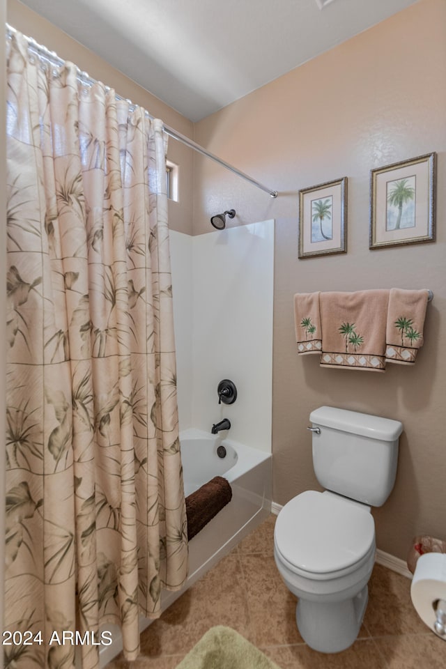 bathroom featuring shower / bath combo, toilet, and tile patterned floors