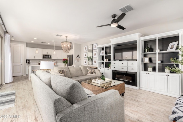 living area featuring recessed lighting, visible vents, light wood-style floors, and ceiling fan