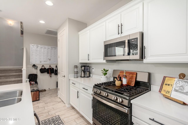 kitchen featuring light countertops, visible vents, appliances with stainless steel finishes, and wood tiled floor