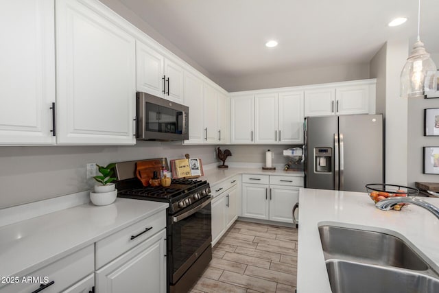 kitchen featuring a sink, white cabinetry, and stainless steel appliances