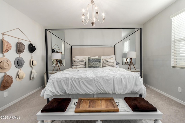 carpeted bedroom with baseboards and an inviting chandelier