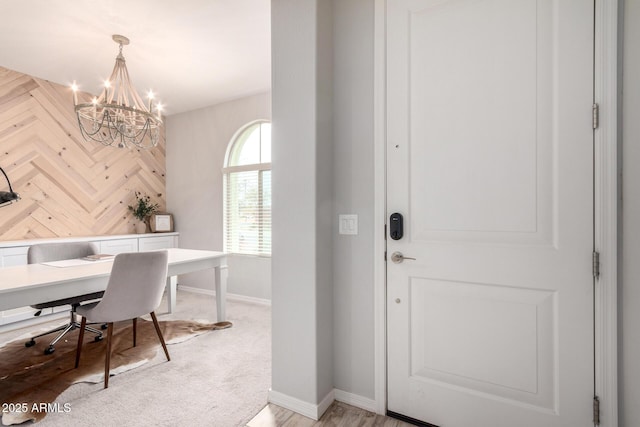 office with a notable chandelier, baseboards, and wood walls