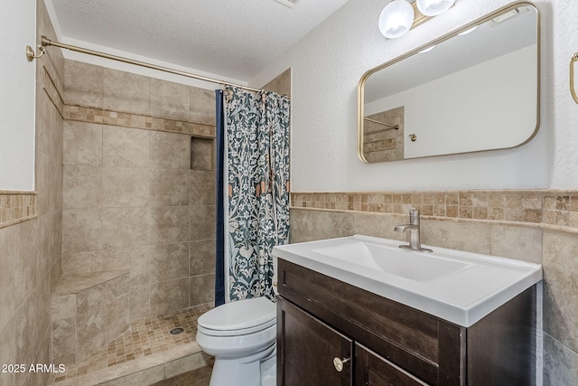 1311 N Congress Dr, Chandler, AZ 85226 - bathroom featuring tile walls, tiled shower, vanity, a textured ceiling, and toilet