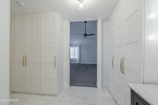1311 N Congress Dr, Chandler, AZ 85226 - bathroom with marble look tile flooring, baseboards, a ceiling fan, vanity, and a textured ceiling
