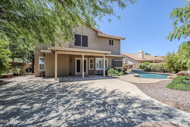 1311 N Congress Dr, Chandler, AZ 85226 - back of property with stucco siding, a patio area, and a pool with connected hot tub