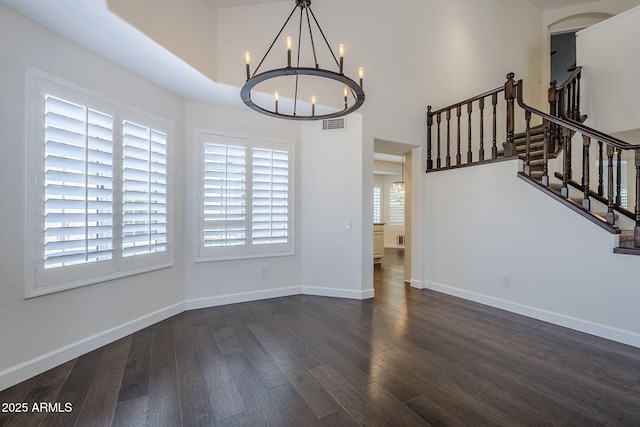 1311 N Congress Dr, Chandler, AZ 85226 - unfurnished dining area with a chandelier, wood finished floors, stairs, and baseboards