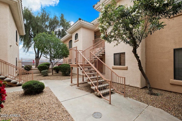 exterior space featuring stairway and fence