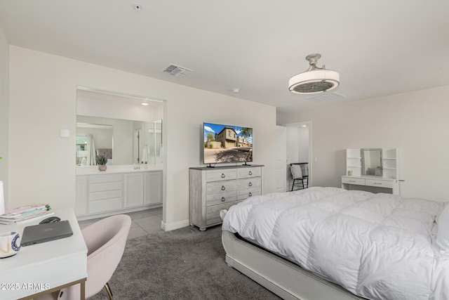 2540 N Stone Hill Rd, Buckeye, AZ 85396 - tiled bedroom featuring visible vents, ensuite bathroom, and carpet