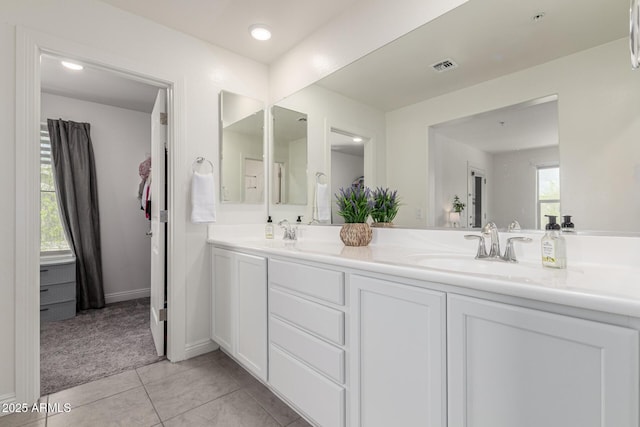 2540 N Stone Hill Rd, Buckeye, AZ 85396 - bathroom featuring visible vents, a sink, tile patterned flooring, and double vanity