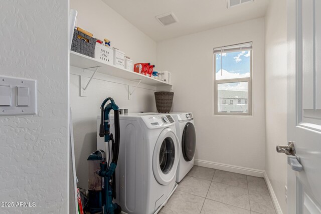 2540 N Stone Hill Rd, Buckeye, AZ 85396 - laundry room featuring laundry area, visible vents, light tile patterned flooring, baseboards, and separate washer and dryer