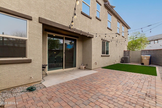 2540 N Stone Hill Rd, Buckeye, AZ 85396 - rear view of house featuring fence, central AC unit, stucco siding, and a patio area