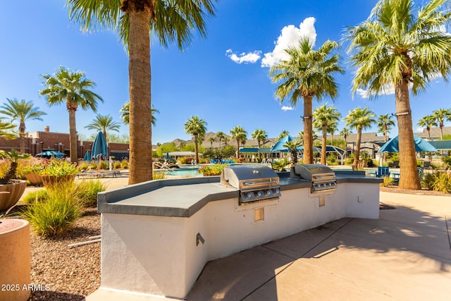 2540 N Stone Hill Rd, Buckeye, AZ 85396 - view of patio with an outdoor kitchen, a community pool, and area for grilling
