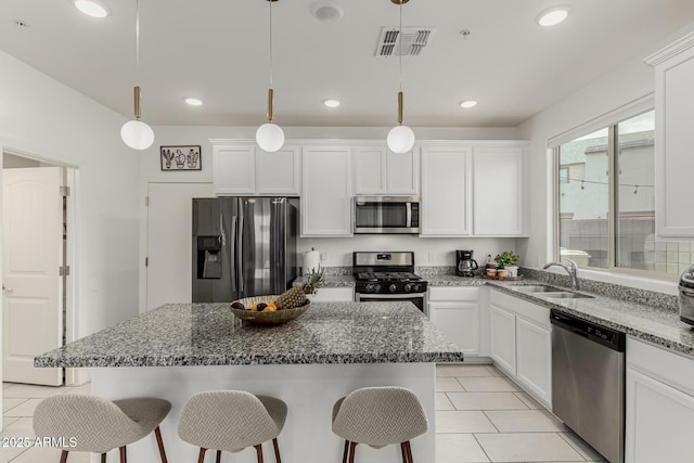 2540 N Stone Hill Rd, Buckeye, AZ 85396 - kitchen with appliances with stainless steel finishes, a breakfast bar, a sink, and visible vents