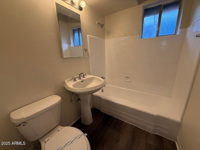 full bathroom with toilet, shower / tub combination, and wood finished floors