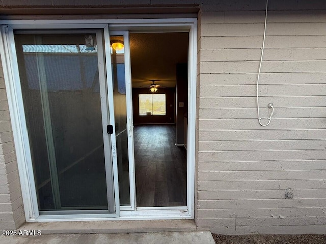 view of exterior entry with brick siding