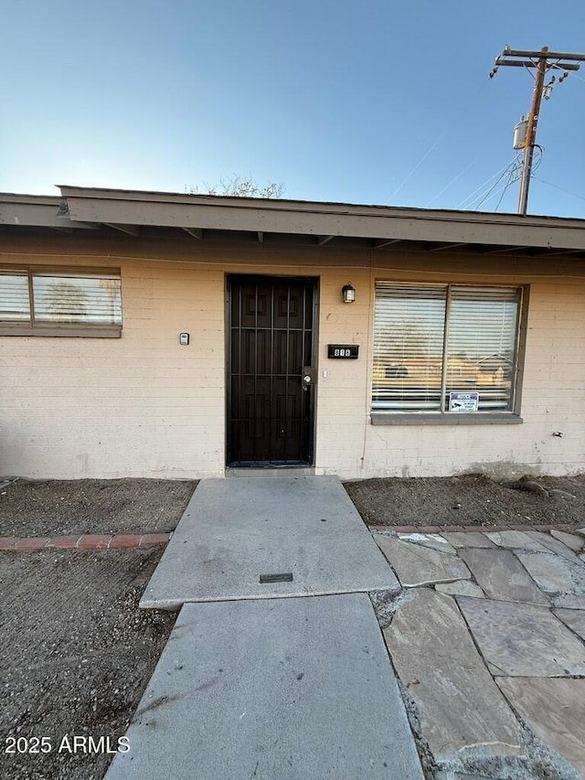 property entrance with brick siding