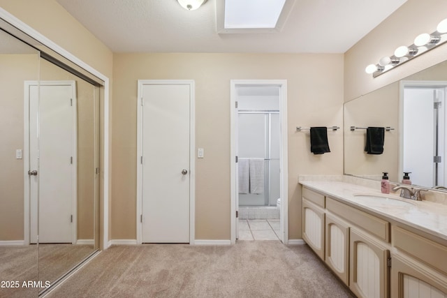 bathroom with carpet flooring, vanity, baseboards, and a stall shower