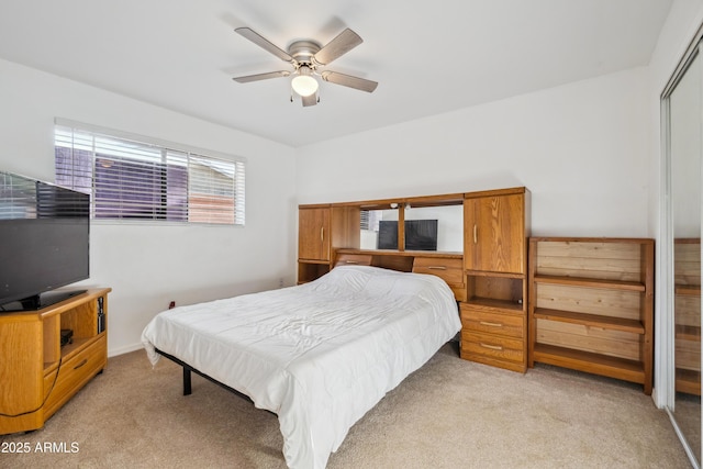 bedroom featuring light carpet, a closet, and ceiling fan
