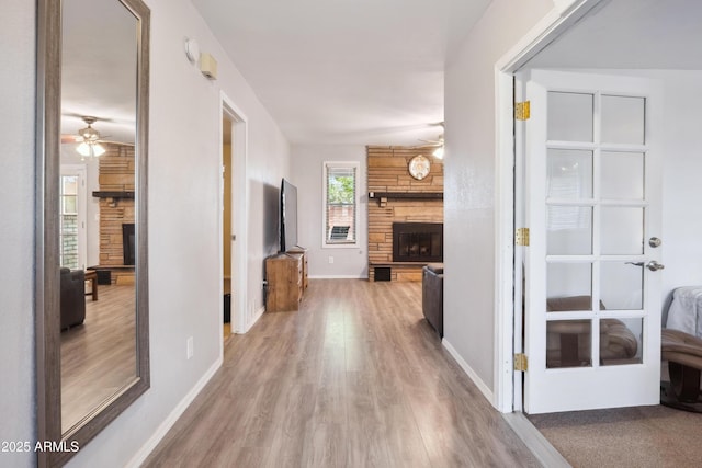 hallway featuring baseboards and wood finished floors