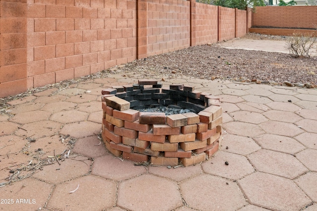 exterior details featuring a fenced backyard and an outdoor fire pit