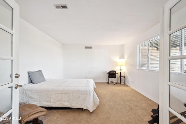 carpeted bedroom with baseboards and visible vents