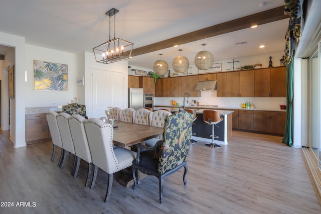 dining space featuring beam ceiling, light hardwood / wood-style flooring, and an inviting chandelier