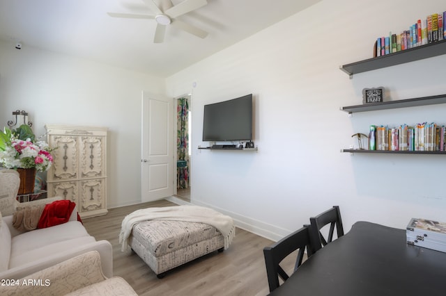 living room featuring light hardwood / wood-style floors and ceiling fan