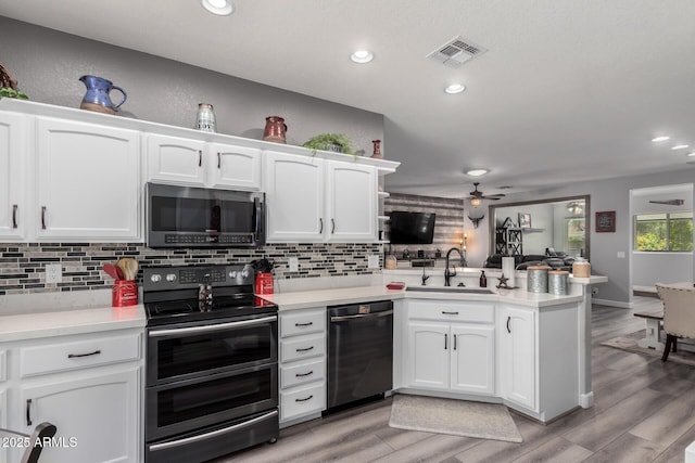 2910 S Olivewood, Mesa, AZ 85212 - kitchen featuring double oven range, dishwasher, a sink, a peninsula, and ceiling fan
