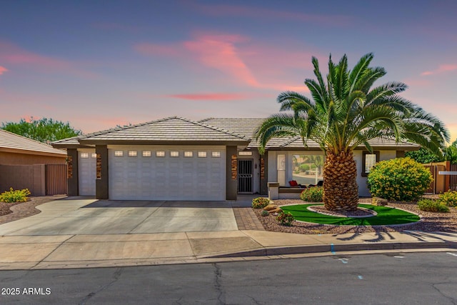 2910 S Olivewood, Mesa, AZ 85212 - view of front of house featuring a garage, concrete driveway, stucco siding, and a tiled roof