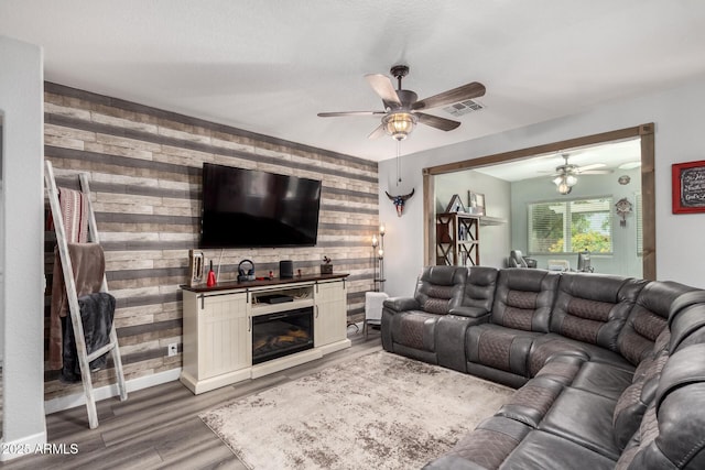 2910 S Olivewood, Mesa, AZ 85212 - living room featuring ceiling fan, wood walls, light wood-style floors, and baseboards