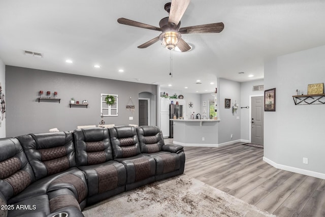 2910 S Olivewood, Mesa, AZ 85212 - living room with ceiling fan, light wood finished floors, recessed lighting, baseboards, and arched walkways