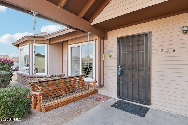 view of exterior entry featuring a porch