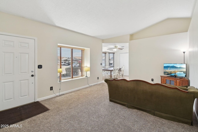 carpeted living room with vaulted ceiling and ceiling fan