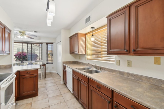 kitchen featuring sink, white appliances, decorative light fixtures, light tile patterned floors, and ceiling fan