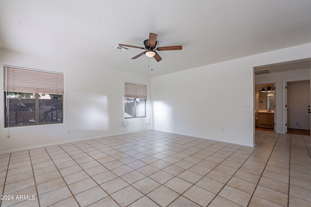 unfurnished room with light tile patterned floors and ceiling fan