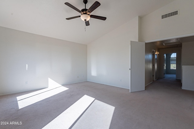 unfurnished room with ceiling fan, light colored carpet, and high vaulted ceiling