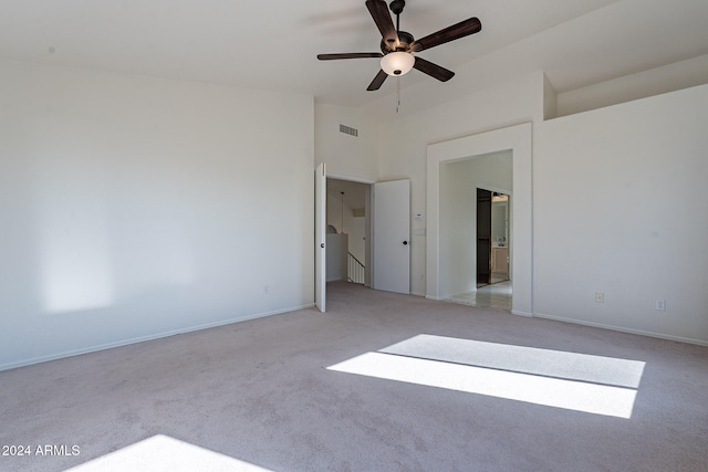 carpeted spare room featuring ceiling fan