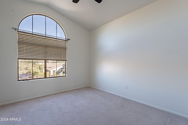 carpeted empty room featuring lofted ceiling and ceiling fan