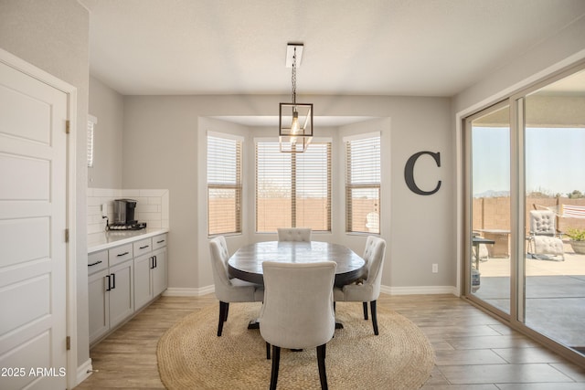 3523 W Rhapsody Dr, Sierra Vista, AZ 85650 - dining area with light wood-type flooring and baseboards